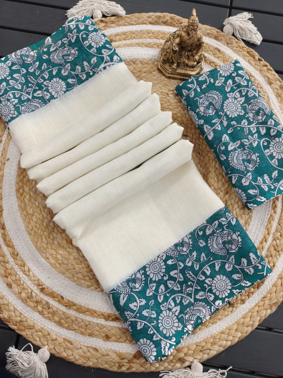 Woman in white linen cotton saree with wine floral printed pallu