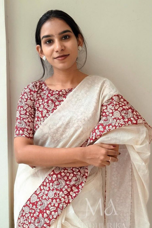 Woman in white linen cotton saree with maroon floral printed pallu
