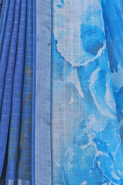 Blue linen saree with silver zari border and watercolor print