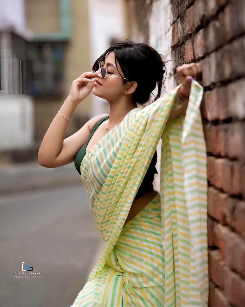 Woman wearing pastel green and yellow striped linen cotton saree