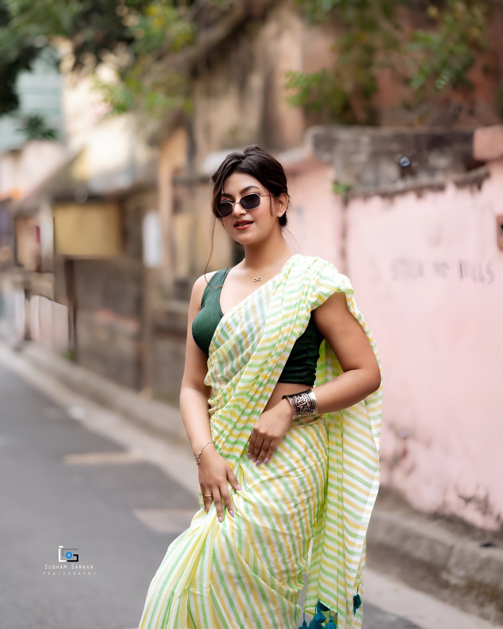 Woman wearing pastel green and yellow striped linen cotton saree