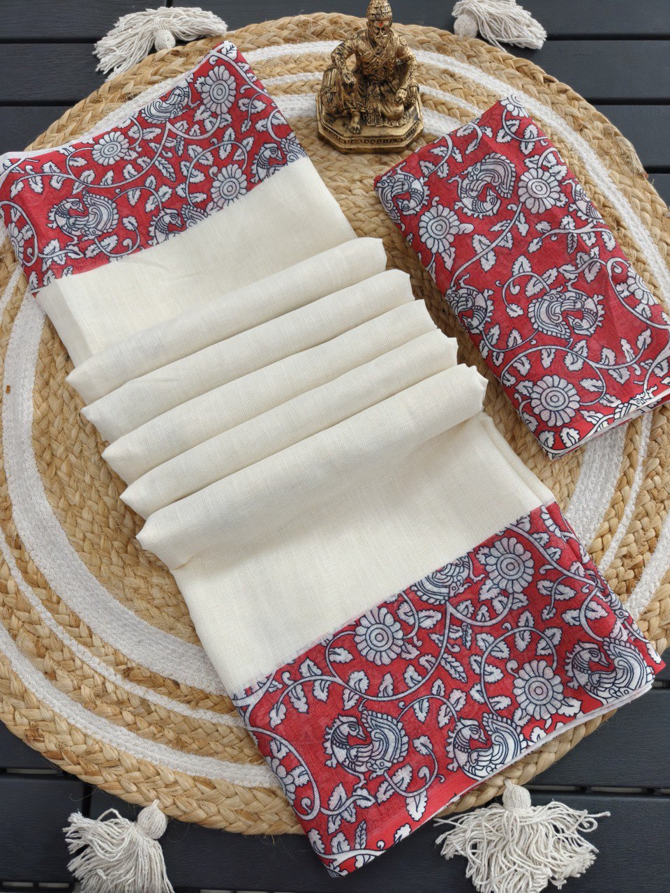 Woman in white linen cotton saree with maroon floral printed pallu