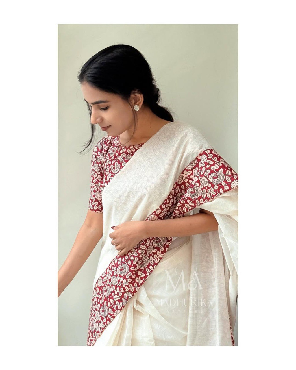 Woman in white linen cotton saree with maroon floral printed pallu