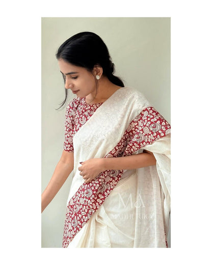 Woman in white linen cotton saree with maroon floral printed pallu